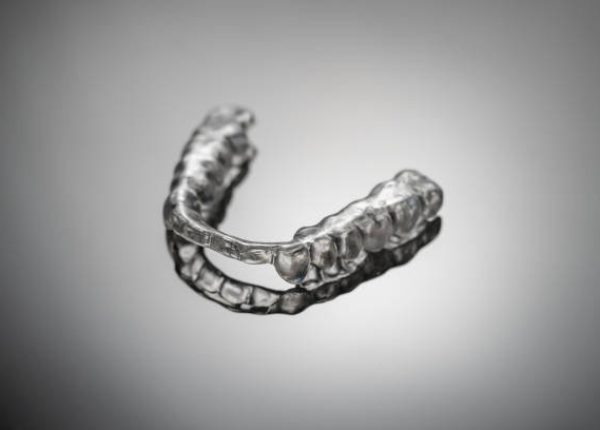 night dental guard by bruxism, on gray background night dental guard by bruxism, on gray background